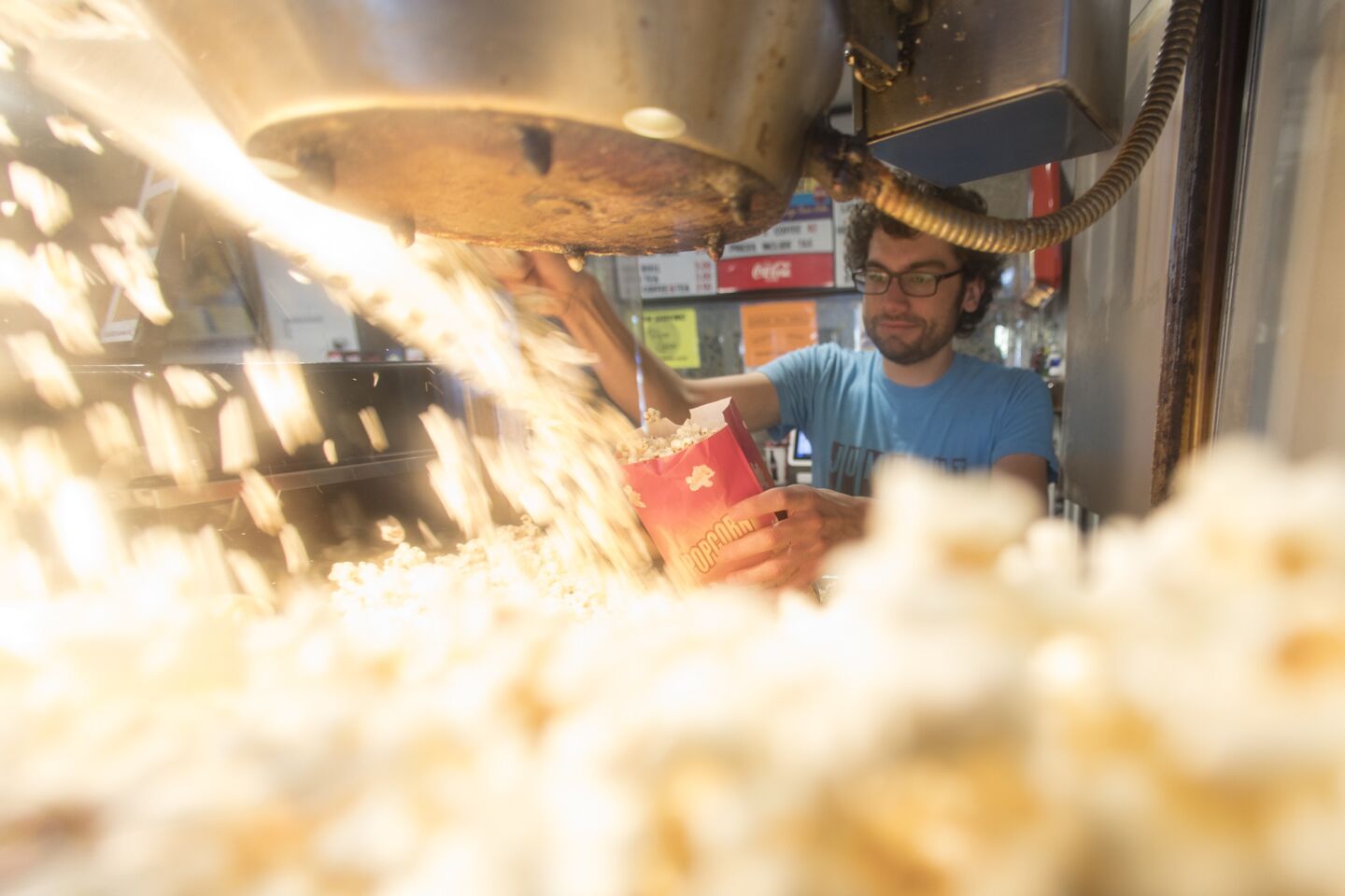 New Beverly Cinema staffer Charlie Tarabour fills a bag of popcorn.