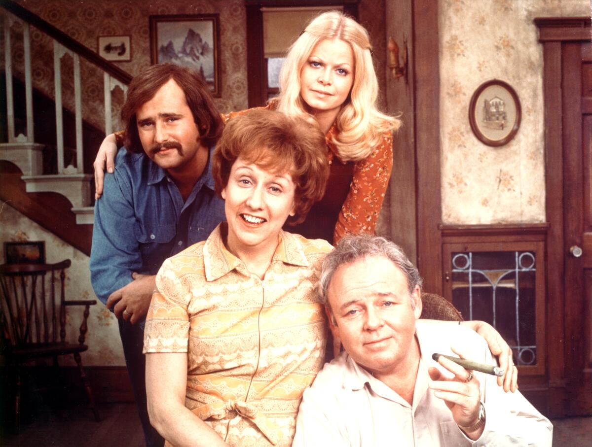The cast of "All in the Family" pose in the living room set.