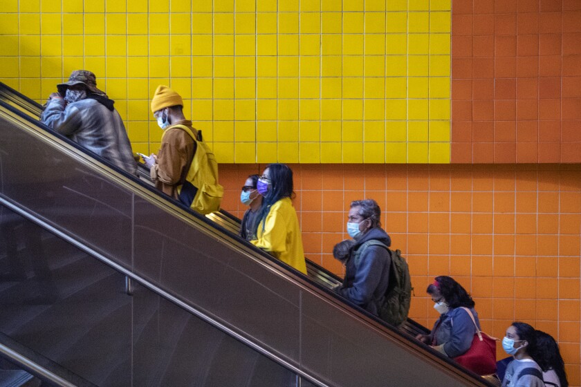 LOS ANGELES, CA - November 16 2021: Commuters ride an escalator up to street level at the North Hollywood station on the Metro Red Line on Tuesday, Nov. 16, 2021 in Los Angeles, CA. (Brian van der Brug / Los Angeles Times