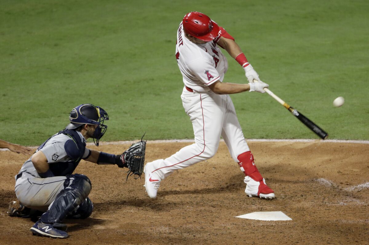 The Angels' Mike Trout connects for a three-run homer against the Mariners on Aug. 29, 2020.