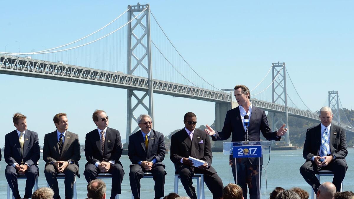 Lt. Gov. Gavin Newsom speaks at a San Francisco news conference with the Golden State Warriors to announce plans to build a new waterfront arena. From left are Rick Welts, Peter Guber, Joe Lacob, Mayor Edwin M. Lee, Ahmad Rashad and Jerry West.