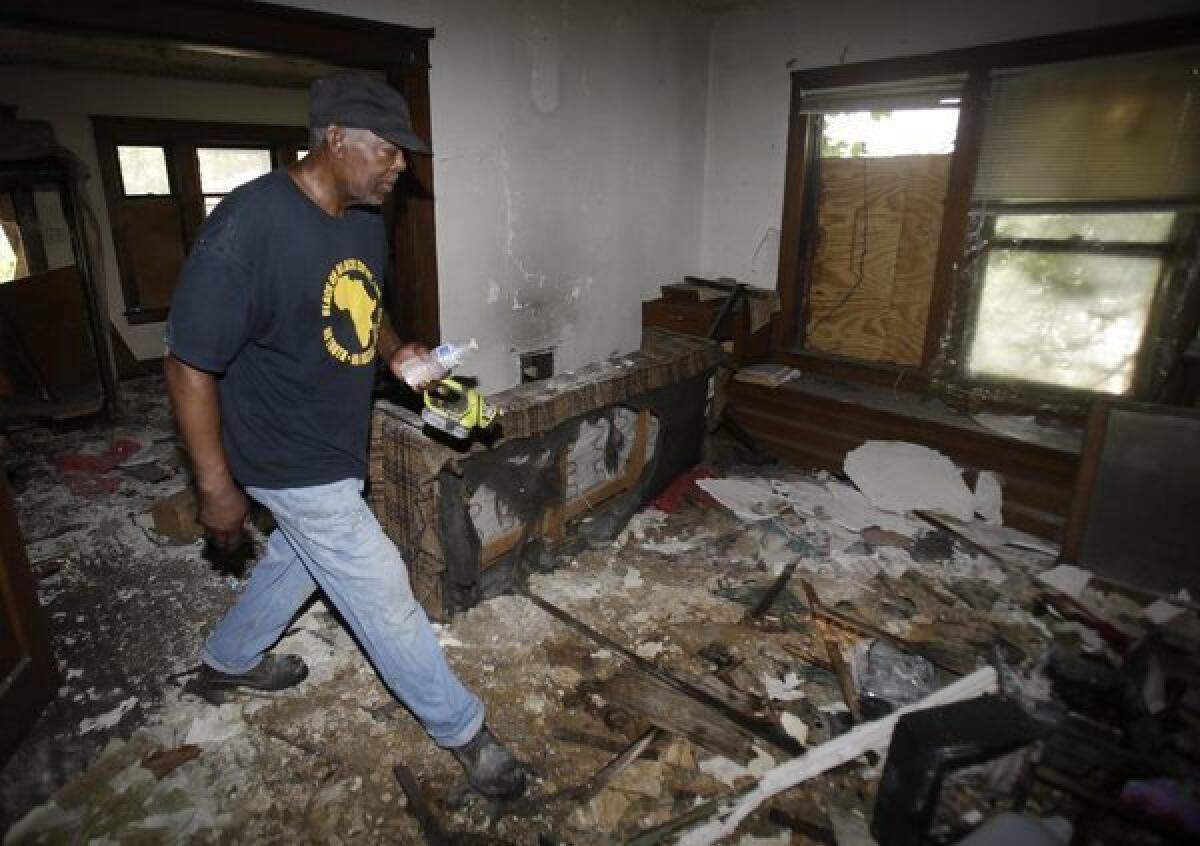 Police told volunteers checking vacant houses in an East Cleveland, Ohio, neighborhood where three bodies were found wrapped in plastic bags that there could be more victims. Above, volunteer searcher Calvin Brooks.
