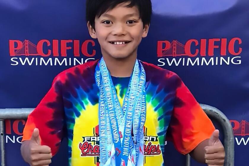 This handout photograph obtained August 3, 2018 courtesy of the Monterey County Aquatic Team shows 10-year-old Clark Kent Apuada on July 29, 2018 after breaking Olympic superstar Michael Phelps' 23-year-old meet record in the 100m butterfly at the Far West International Championship in Morago, California. Phelps offered a Twitter shout-out after Apuada broke the meet record: "Big congrats to #clarkkent for smashing that meet record!!! Keep it up dude!! #dreambig". Apuada won the 10-and-under 100m fly in 1:09.38 -- more than a second faster than the record established by Phelps at the same event in California in 1995. / AFP PHOTO / Monterey County Aquatic Team / HO / == RESTRICTED TO EDITORIAL USE / MANDATORY CREDIT: "AFP PHOTO / MONTEREY COUNTY AQUATIC TEAM" / NO MARKETING / NO ADVERTISING CAMPAIGNS / DISTRIBUTED AS A SERVICE TO CLIENTS == HO/AFP/Getty Images ** OUTS - ELSENT, FPG, CM - OUTS * NM, PH, VA if sourced by CT, LA or MoD **