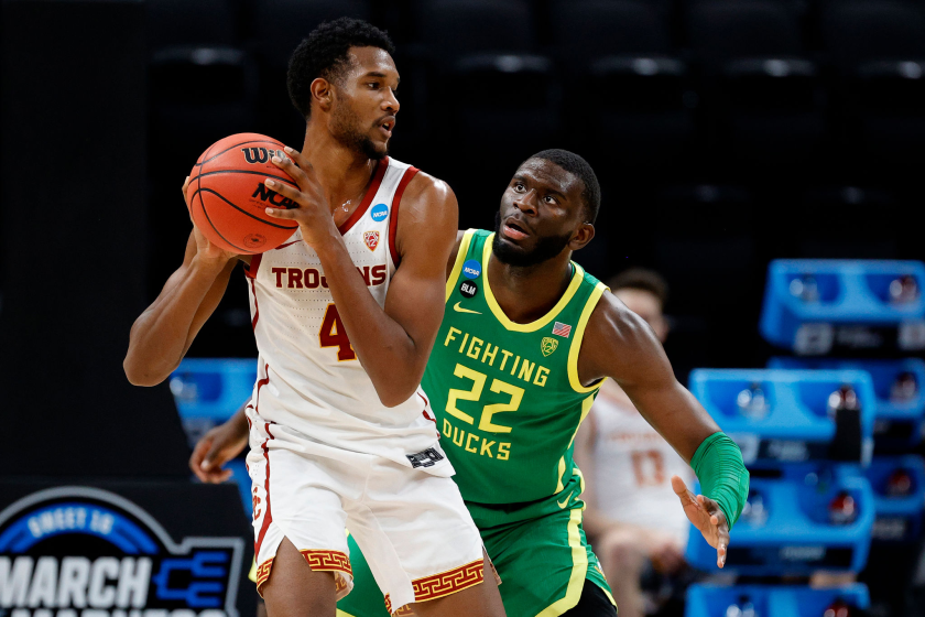 INDIANAPOLIS, INDIANA - MARCH 28: Evan Mobley #4 of the USC Trojans looks to pass against Franck Kepnang.