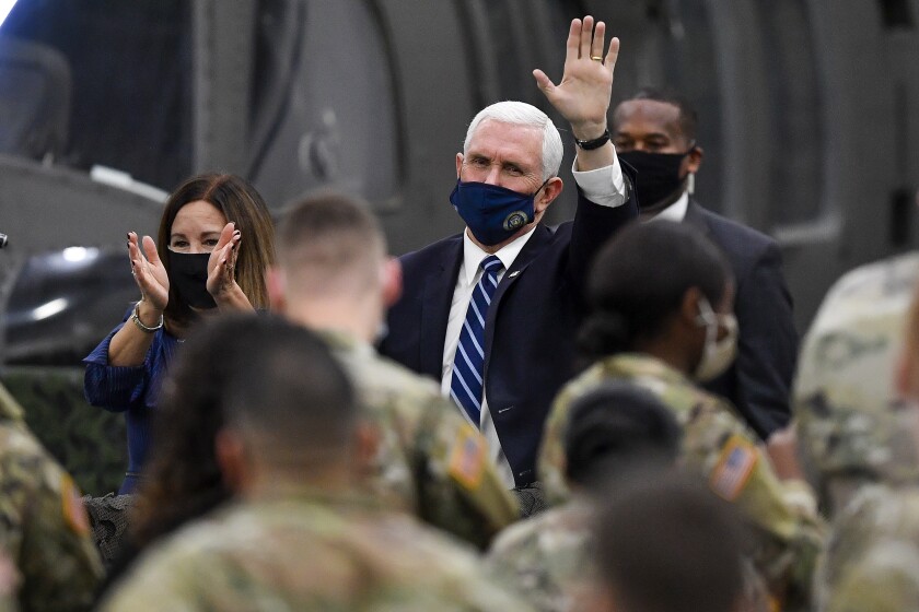 Vice President Mike Pence, right, and second lady Karen Pence, left, acknowledge military personnel after addressing the Army 10th Mountain Division soldiers, many of whom have recently returned from Afghanistan, in Fort Drum, N.Y., Sunday, Jan. 17, 2021. (AP Photo/Adrian Kraus)