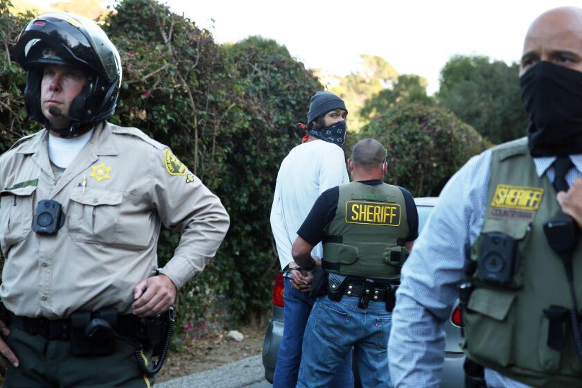  Eman is arrested or detained following a protest outside Sheriff Alex Villanueva's home in La Habra Heights