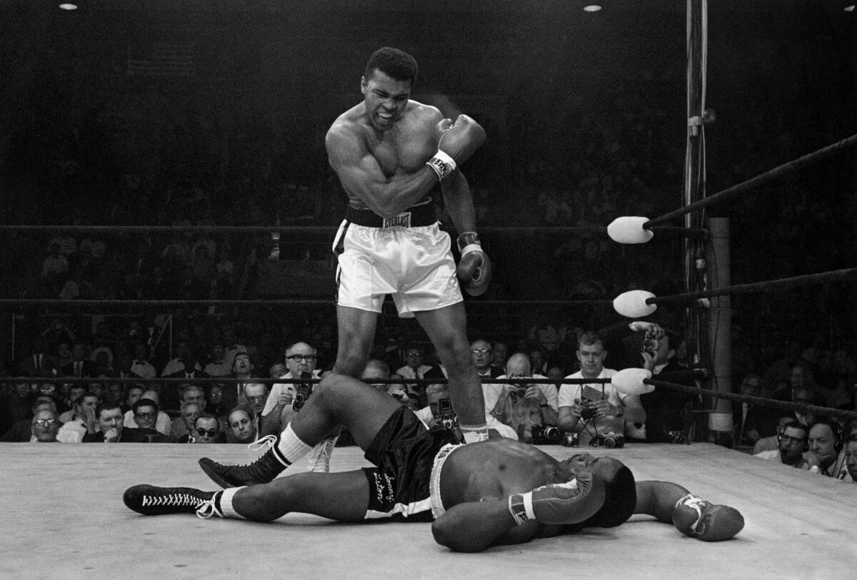 Heavyweight champion Muhammad Ali stands over fallen challenger Sonny Liston