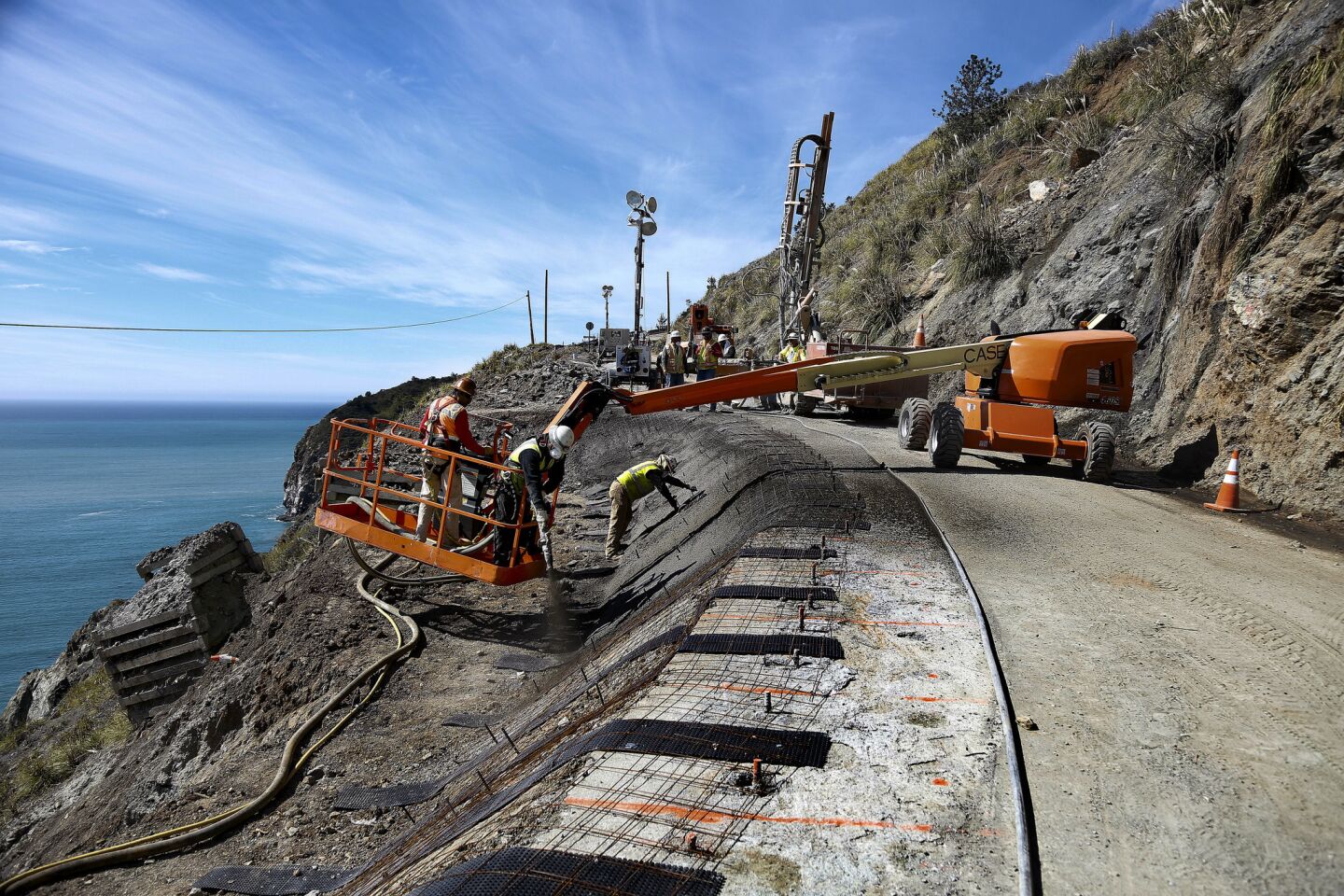 Workers take steps to stabilize the slope after a landslide took out the southbound lane and part of the shoulder in a section of Highway One known as Paul's Slide along the Big Sur coast.