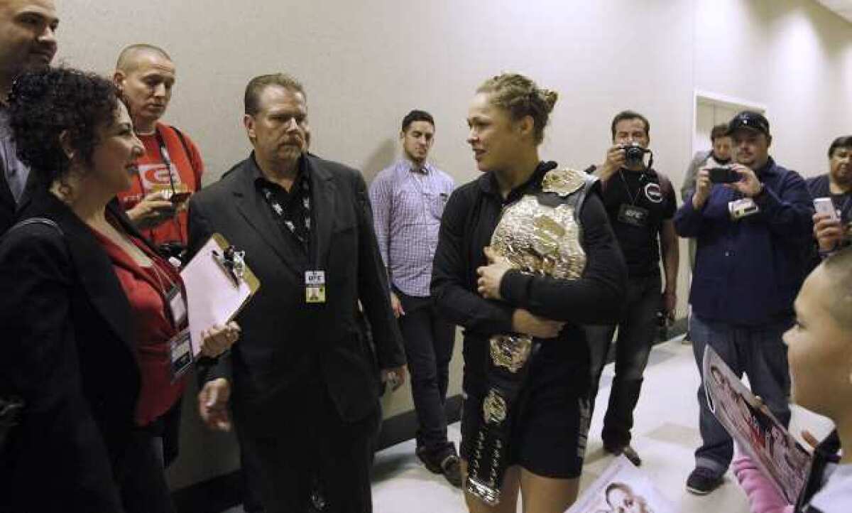Glendale Fighting Club trained Ronda Rousey, center, meets some of her fans after beating ex-Marine Liz Carmouche in the first round of the UFC 157.