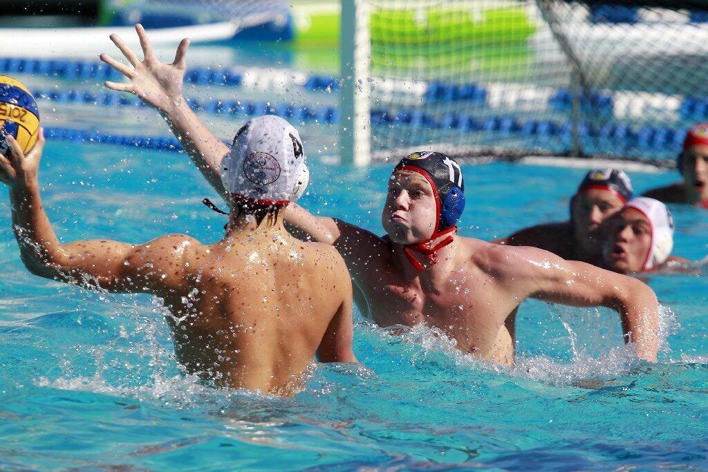 Regency Water Polo's Jackson Seybold (17) pressures a Stanford opponent during the first half in the USA Junior Olympics 18U boys' bronze match at the William Woollett Aquatic Center in Irvine on Tuesday.