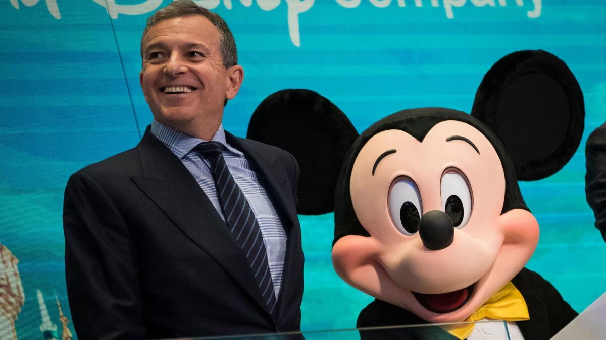 Walt Disney Co. Chief Executive Bob Iger and Mickey Mouse get ready to ring the opening bell at the New York Stock Exchange in November.