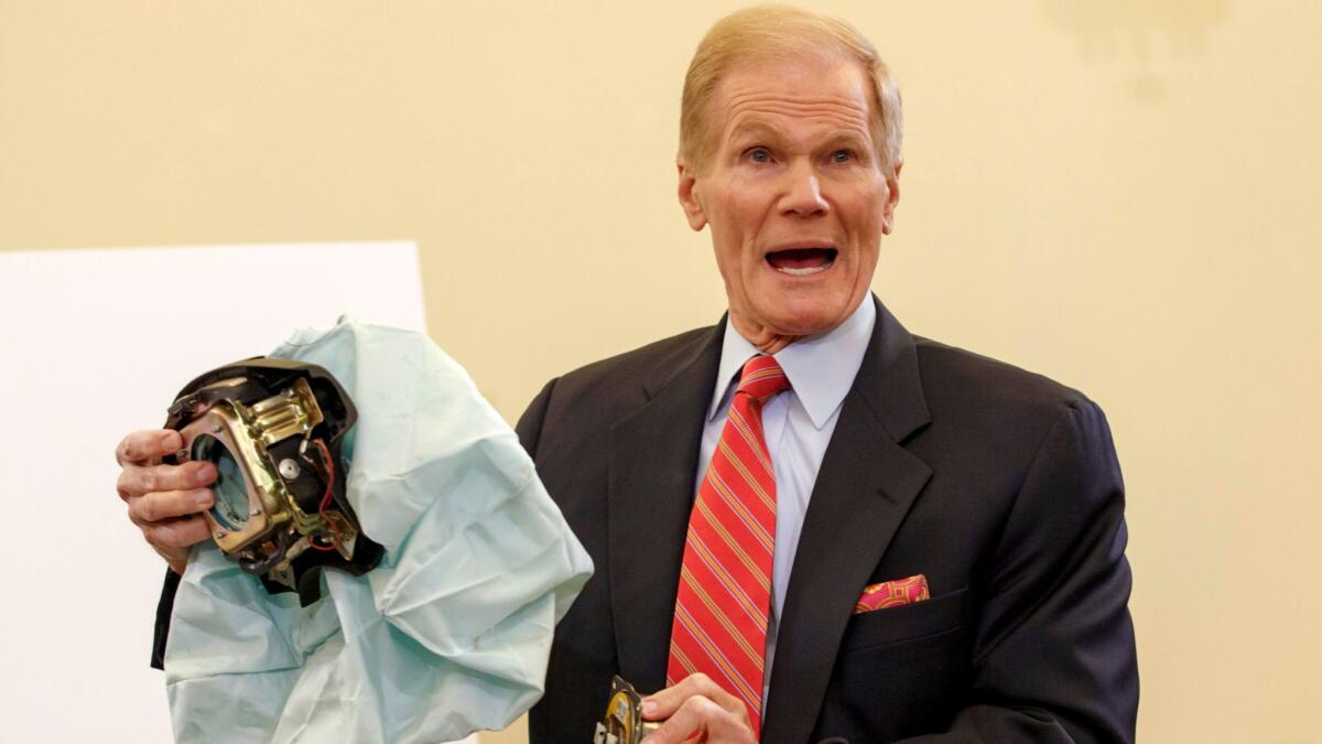 Sen. Bill Nelson (D-Fla.) holds an example of a defective Takata airbag in 2014.