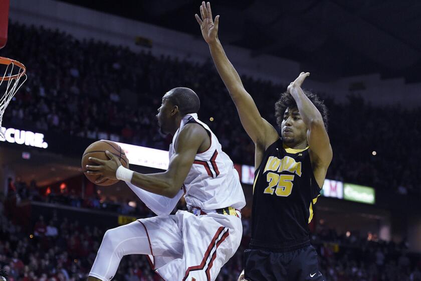 Maryland's Rasheed Sulaimon, left, drives to the basket around Iowa's Dom Uhl in the second half on Thursday.