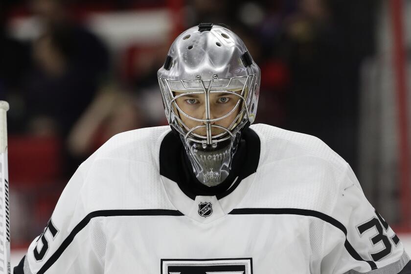 Los Angeles Kings goalie Darcy Kuemper (35) peers through his mask during the second period.
