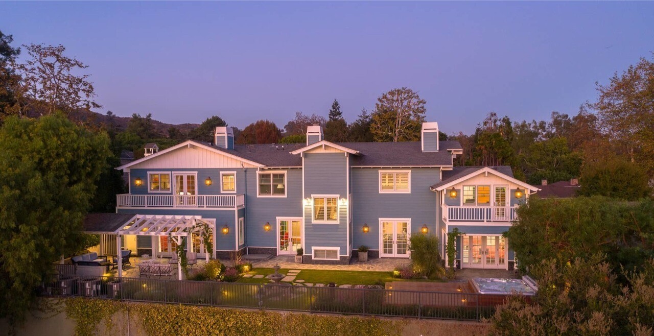 The three-story home sits on an ocean-view knoll near Will Rogers State Historic Park.