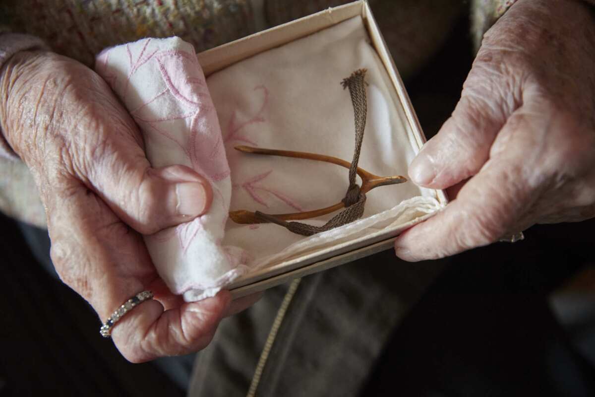 U.S. veteran Ellan Levitsky, 99, holds her chicken wishbone, one of her few mementos from her work as a staff nurse in a military hospital in Normandy, France, during World War II.