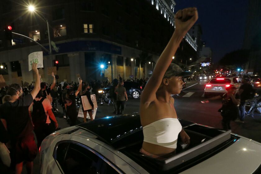 LOS ANGELES, CALIF. - JUNE 3, 2020. Thousands of protesters march down Spring Street in Los Angeles to demonstrate for justice in the George Floyd murder by cop case on Wednesday, June 3, 2020. (Luis Sinco/Los Angeles Times)