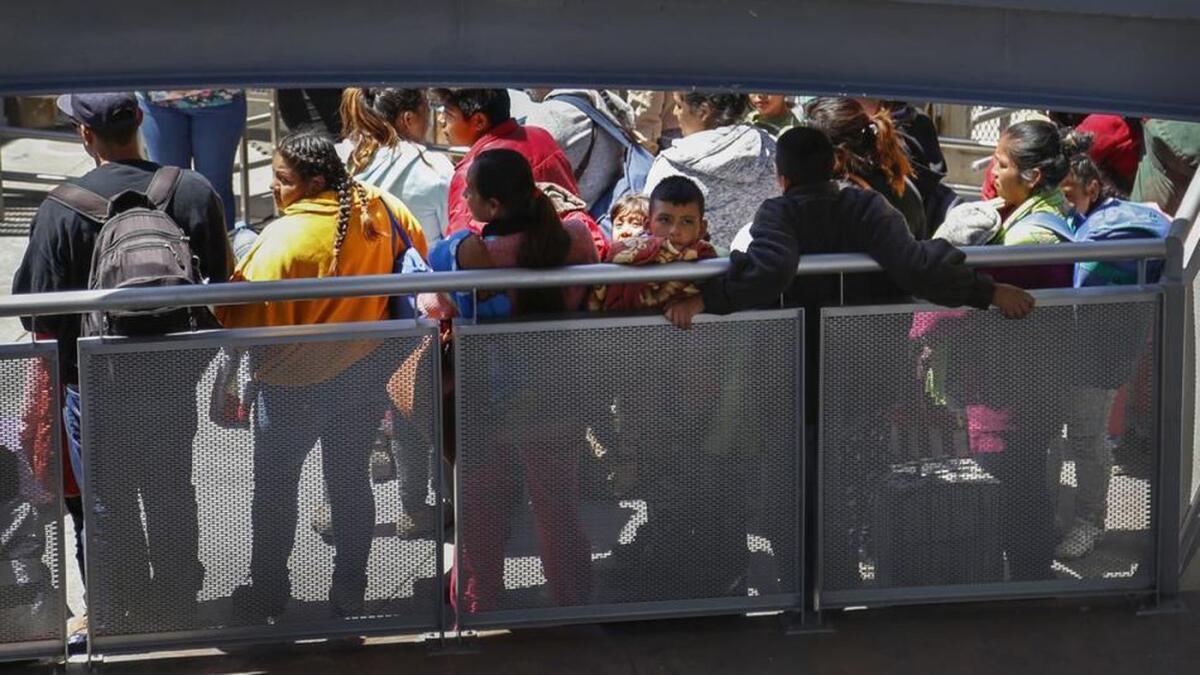 A group of asylum seekers waits to be processed at the San Ysidro Port of Entry south of San Diego.