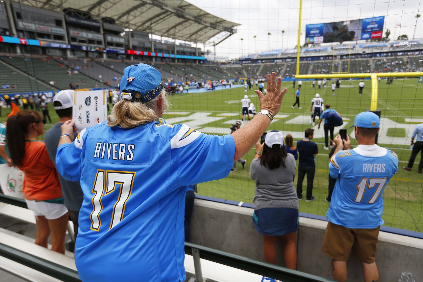 Fan Debbie Burke cheers on Philip Rivers as he warms up before the Los Angeles Chargers played the Miami Dolphins at the StubHub Center on Sunday, Sept. 17, 2017.