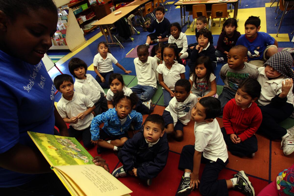 Kindergarten students listen to teacher Aisha Blanchard-Young, 36, read them a story at the Bennett-Kew Elementary School in Inglewood in 2011.