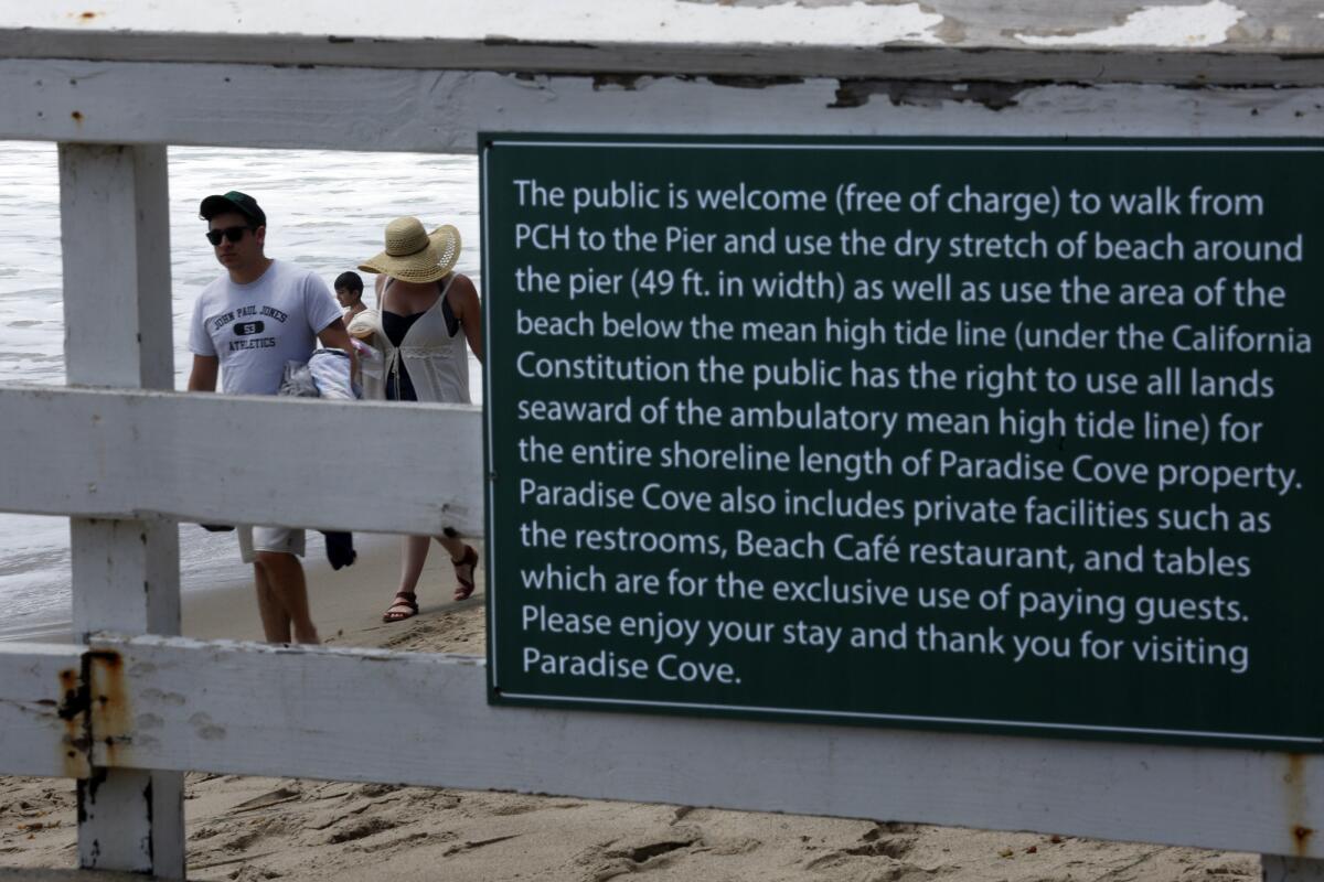 A sign is posted on the Paradise Cove Pier that instructs visitors on what areas of their property is open to the public at Paradise Cove.