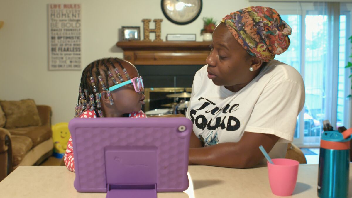 A young girl and her mom read during a scene in "The Right to Read."