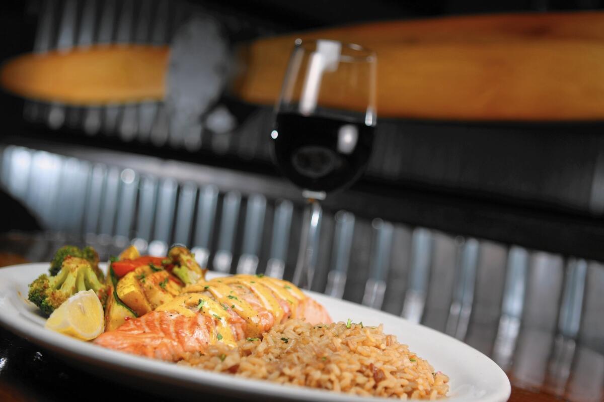 A favorite at the Hangar Grille in Burbank is the fresh grilled salmon stuffed with crab meat filling and topped with a red pepper aioli sauce with a side of rice pilaf and sauteed vegetables.