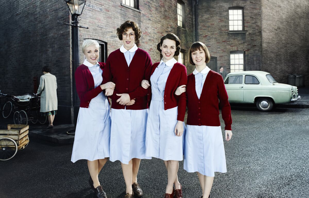 Four people arm-in-arm dressed in nurses uniforms.