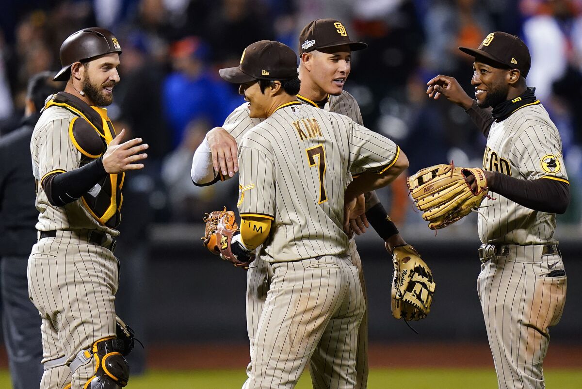 The San Diego Padres players celebrate after defeating the New York Mets in Game 3 of the NL Wildcard Playoff Series.