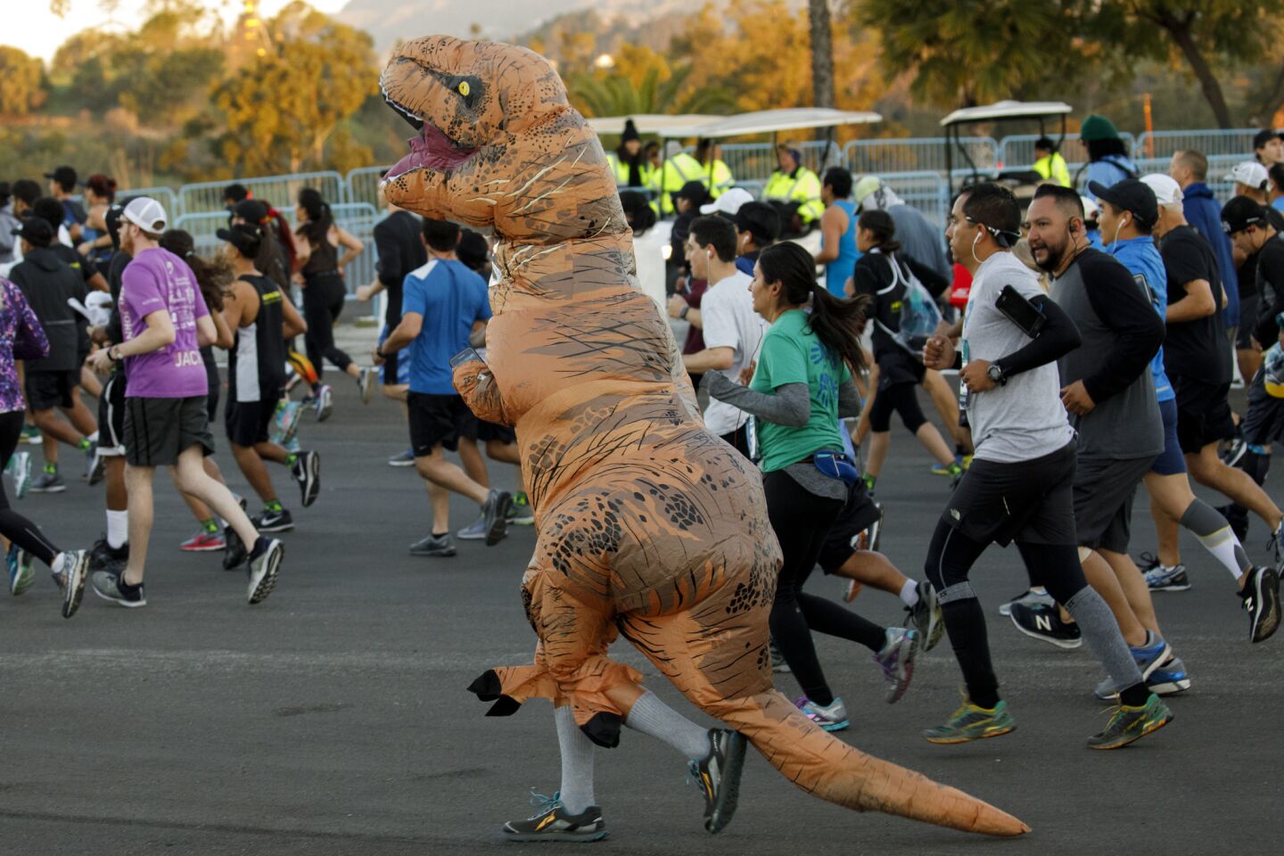 A participant runs in a dinosaur costume at the start of the L.A. Marathon on Sunday.