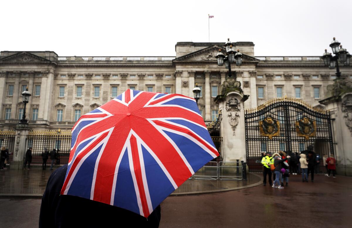 Tourist's umbrella emblazoned with British flag, outside Buckingham Palace