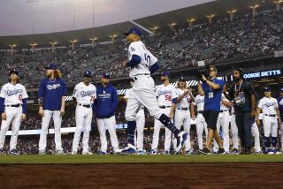 Dodgers right fielder Mookie Betts jogs past the rest of the team as he is introduced before game one of the NLDS 