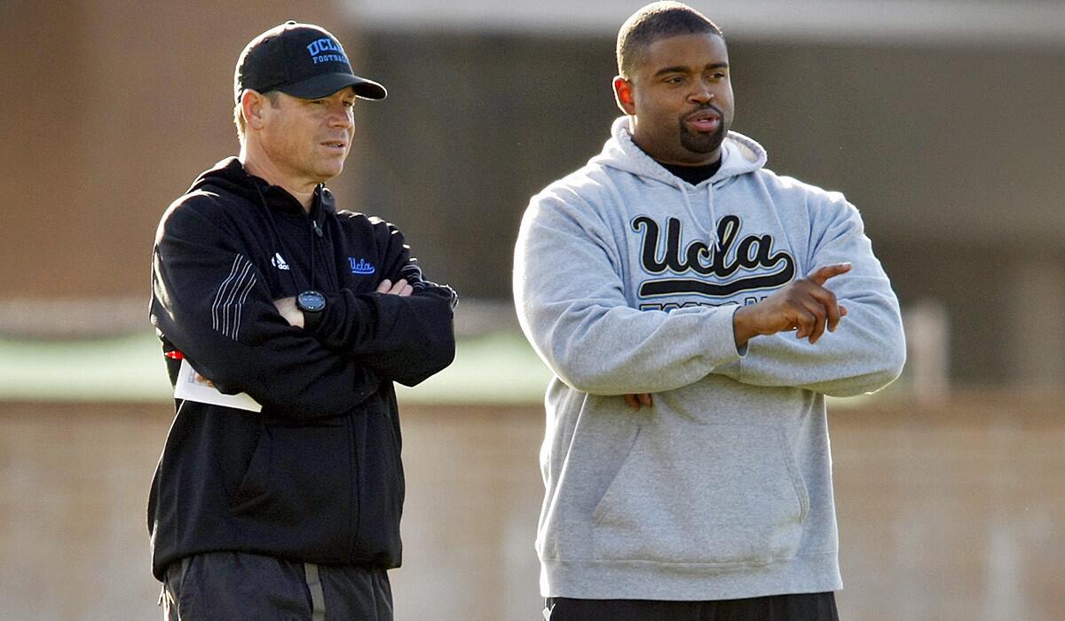 UCLA Coach Jim Mora, left, and offensive line coach Adrian Klemm watch the Bruins during spring practice.