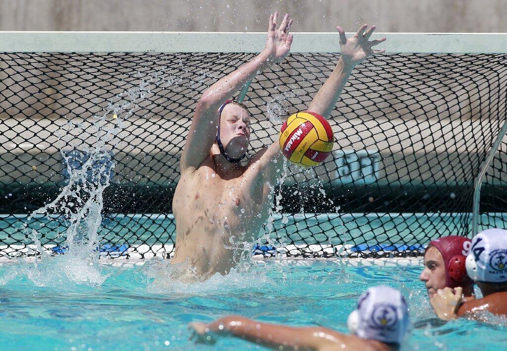 Goalkeeper Cal Meyer of Newport Beach Water Polo blocks a shot during the first half in the USA Junior Olympics 14U boys' bronze match at the William Woollett Aquatic Center in Irvine on Tuesday.