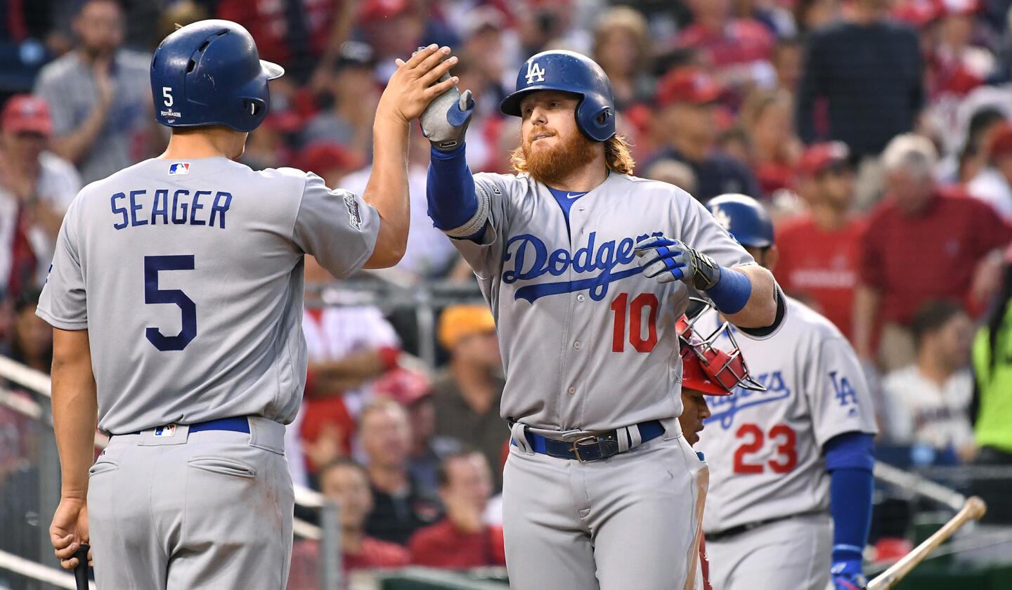 Dodgers third baseman Justin Turner celebrates his two-run home run with teammate Corey Seager in the third inning against the Nationals in Game 1 of the NLDS at Nationals Park on Friday.