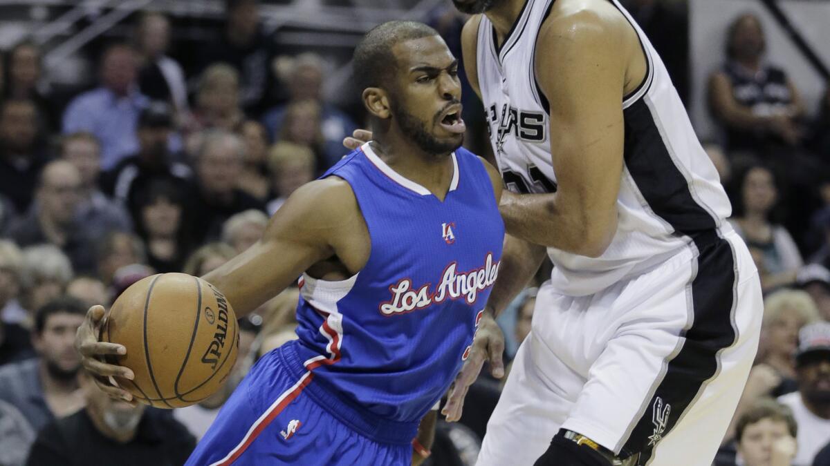 Clippers point guard Chris Paul drives around Spurs forward Tim Duncan during the Clippers' win in Game 4 of the Western Conference quarterfinals in San Antonion on April 26.