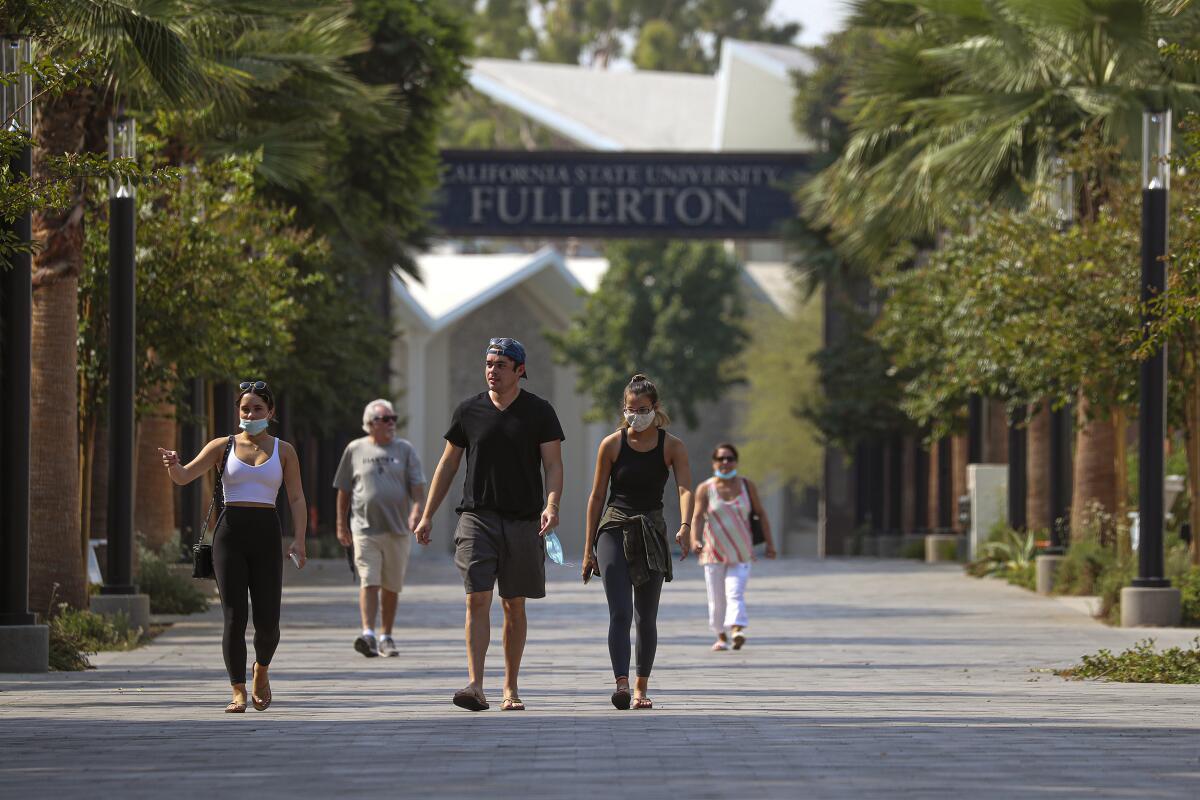 New student Olivia Murphy, 20, left in white top, takes her family on a tour of Cal State Fullerton in August.