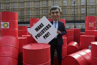 Oxfam's Rishi Sunak 'big head' protests outside the Parliament in London, Tuesday, Sept. 19, 2023. On the eve of the UN Climate Ambition Summit, Oxfam's Rishi Sunak 'big head' staged a protest on top of a giant oil barrel, amongst dozens of real oil drums, supporting the Make Polluters Pay campaign. Calling for oil and gas giants, such as BP and Shell, to pay more tax to raise critical funds to help communities devastated by climate change. (AP Photo/Kin Cheung)