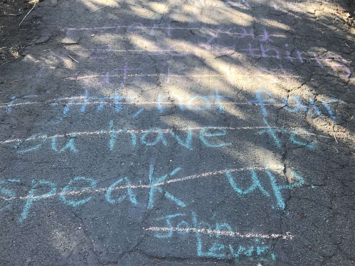 Many of the latest chalk drawings and messages, like this quote from late Congressman John Lewis, were crossed out.