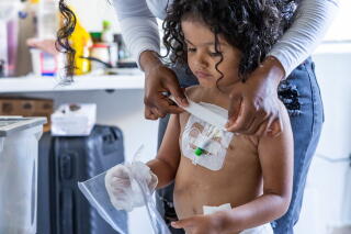 a woman covers up her daughter's intravenous attachments