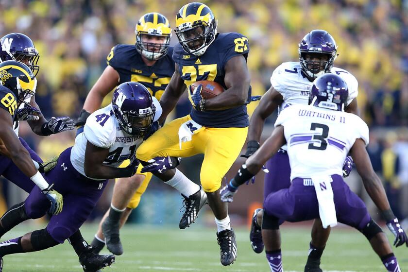 Michigan running back Derrick Green runs for a first down during the fourth quarter against Northwestern defenders on Saturday.