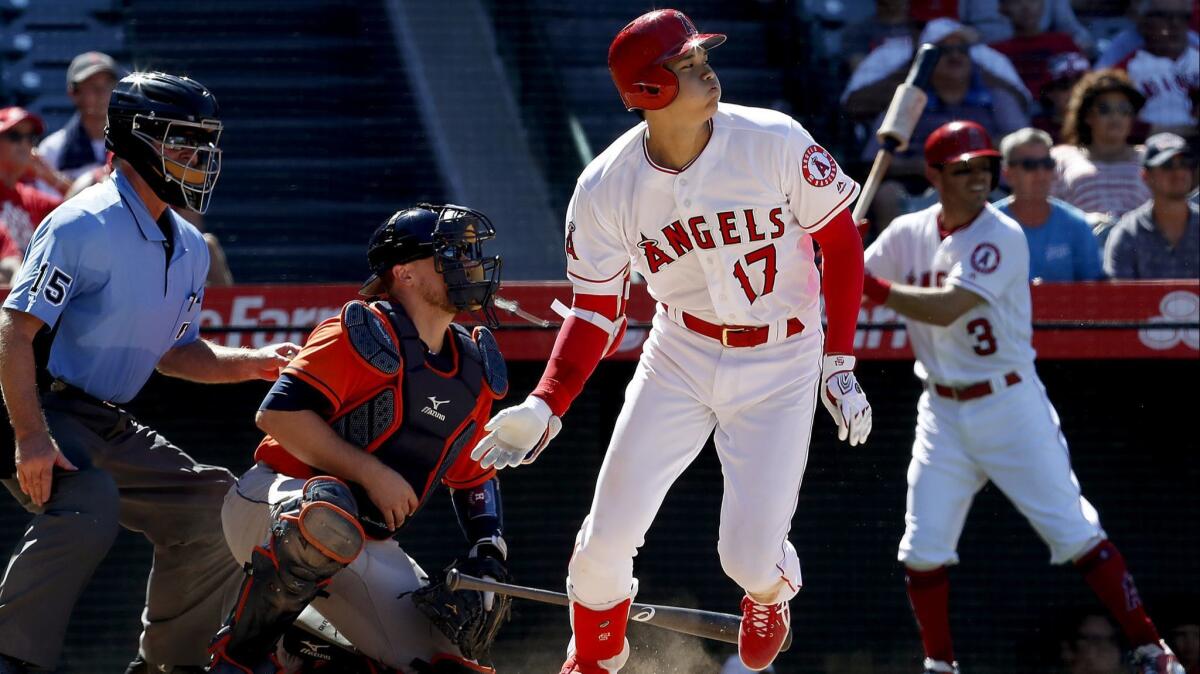 Angels designated hitter Shohei Ohtani hits a single against the Houston Astros in the seventh inning Sunday at Angel Stadium.