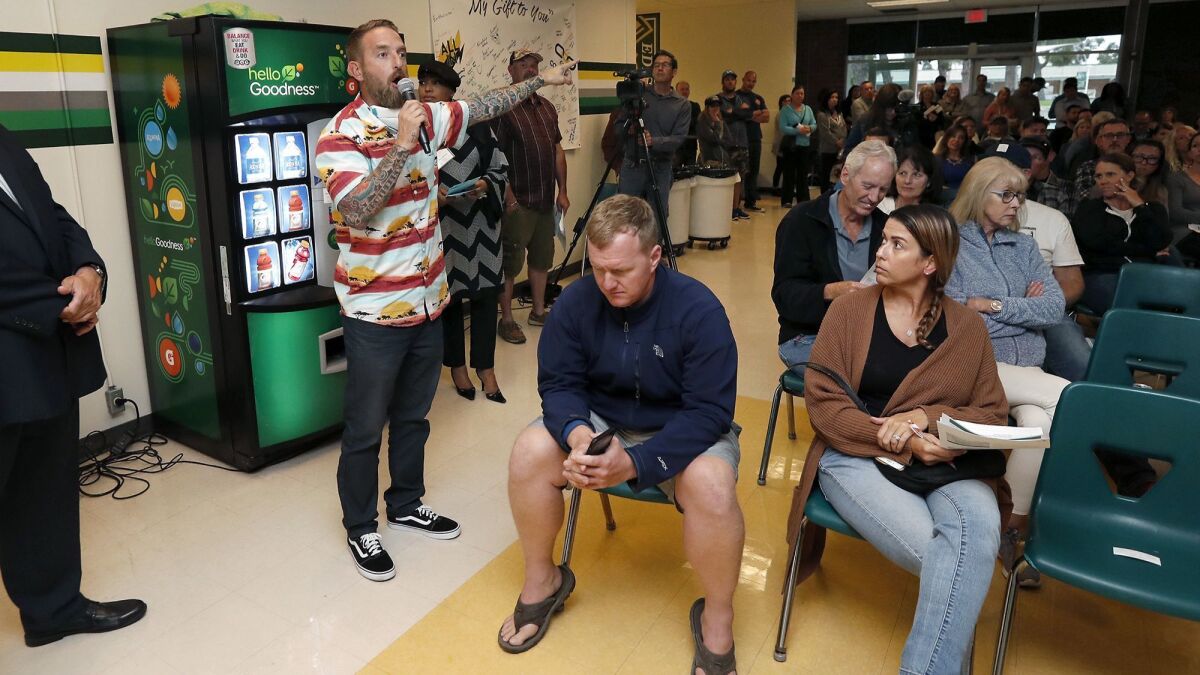 Huntington Beach resident Ryan Messick voices his concerns during a community meeting Thursday at Edison High School during which state and regional air quality officials discussed how they are handling the 18-month cleanup currently underway at the former Ascon landfill site.