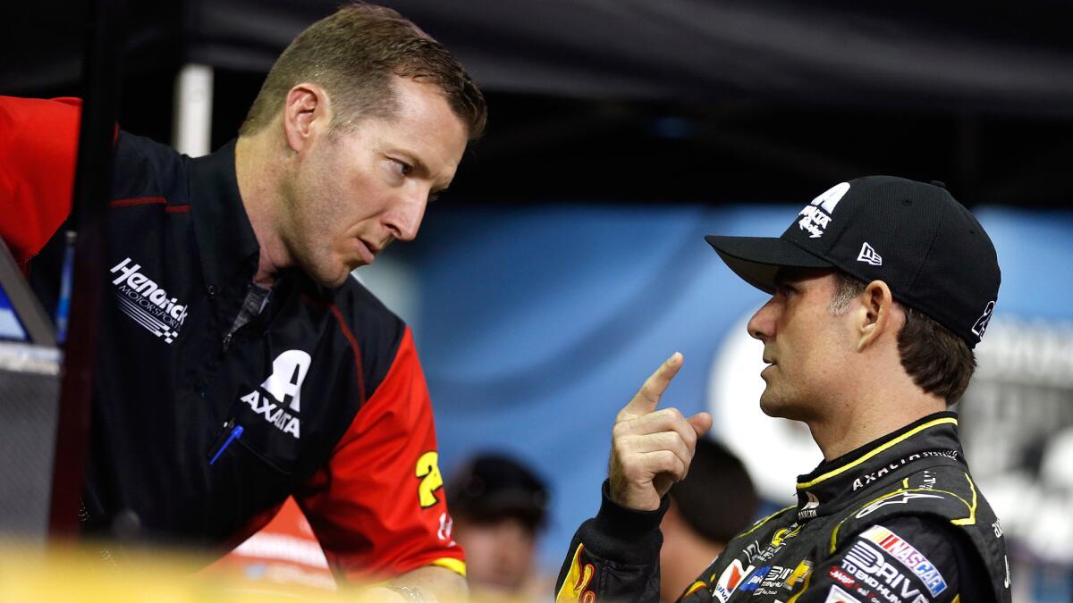 NASCAR driver Jeff Gordon, right, talks to crew chief Alan Gustafson on Friday during qualifying for the NASCAR Sprint Cup Series Ford EcoBoost 400 at Homestead-Miami Speedway.