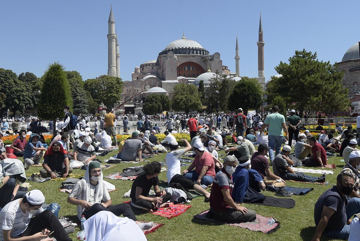 Worshipers wait outside the Hagia Sophia in Istanbul