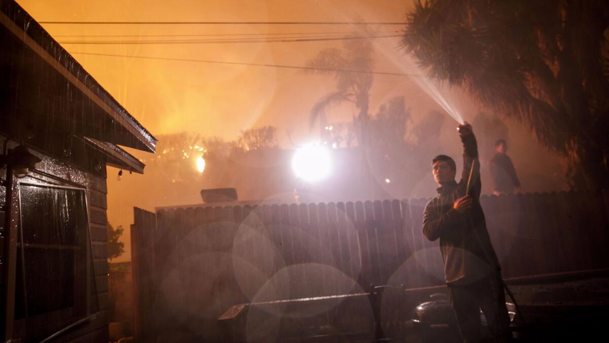 John Bain and his friends, all from Camarillo, came to help out as brush fires moved quickly, burning through residential neighborhoods in Ventura.