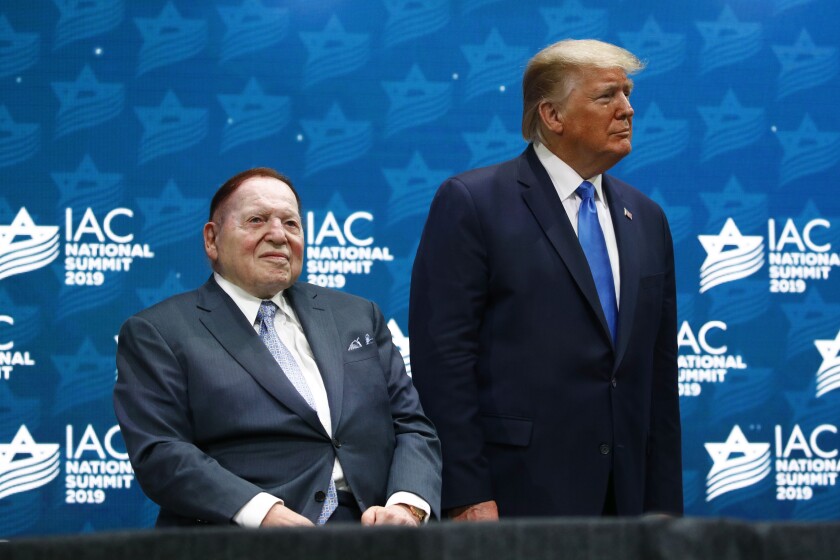 FILE - In this Dec. 7, 2019 file photo, President Donald Trump stands alongside Las Vegas Sands Corporation Chief Executive and Republican mega donor Sheldon Adelson before speaking at the Israeli American Council National Summit in Hollywood, Fla. Adelson, the billionaire mogul and power broker who built a casino empire spanning from Las Vegas to China and became a singular force in domestic and international politics has died after a long illness, his wife said Tuesday, Jan. 12, 2021. (AP Photo/Patrick Semansky, File)