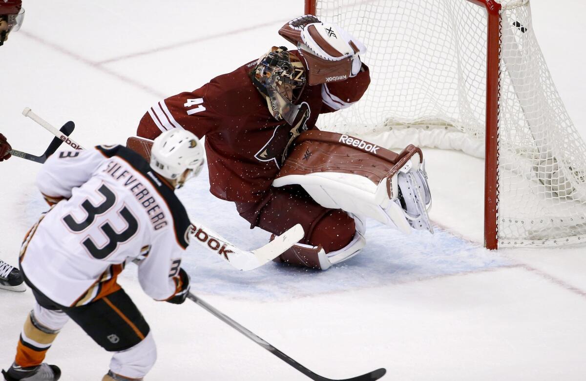 Jakob Silfverberg scores a goal against Arizona goalie Mike Smith during the second period Saturday night in Glendale.