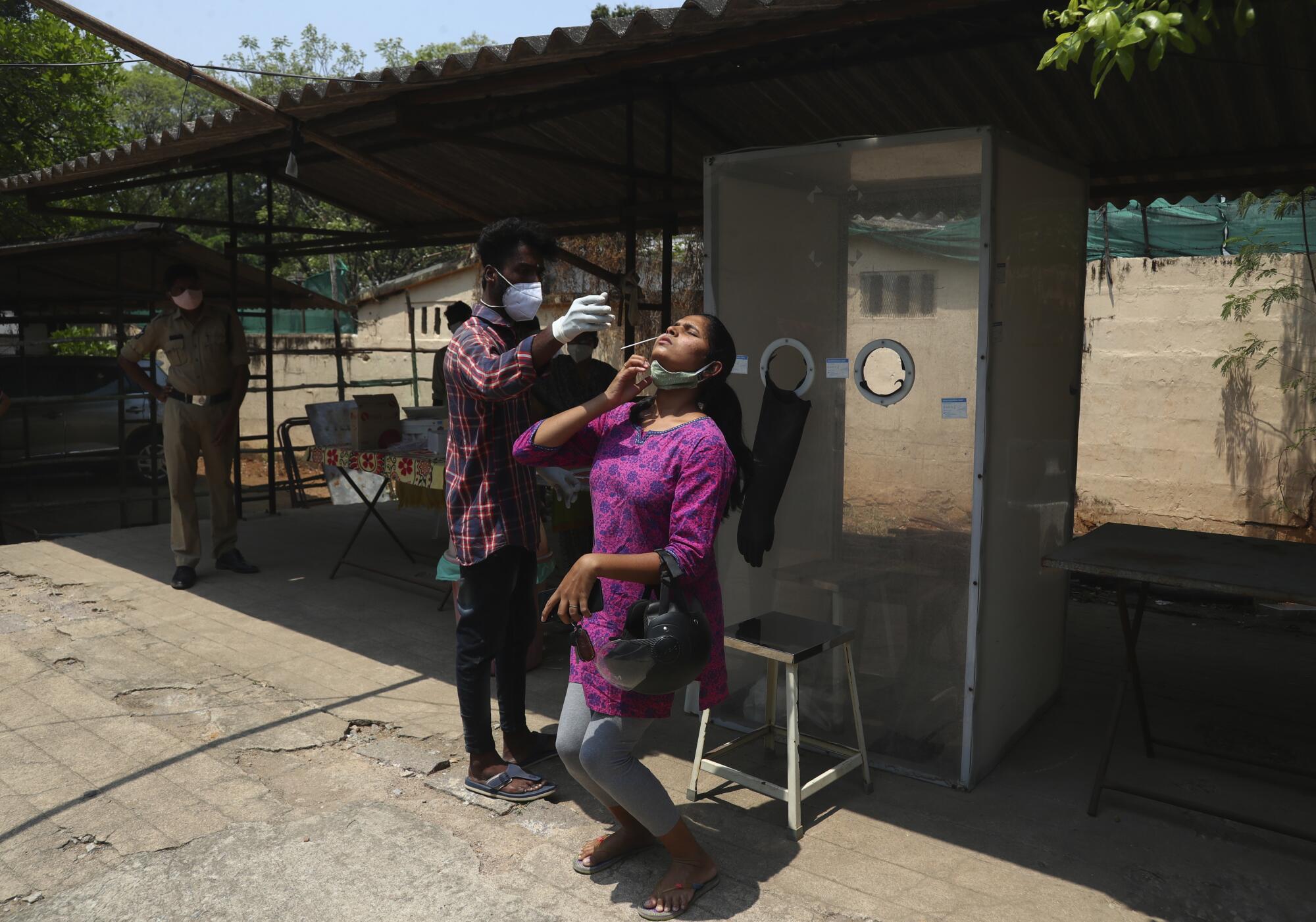 A health worker takes a nasal swab