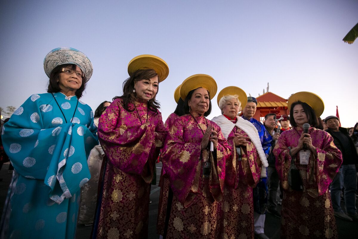 Vietnamese elders pray over a deity during the opening day of the Tet Festival at the O.C. Fairgrounds.